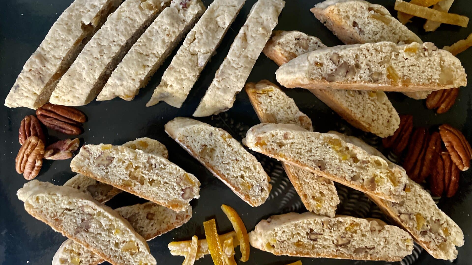 Candied Orange Peel Pecan Biscotti on a green platter