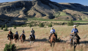 Riders on horseback at Wilson Ranches Retreat